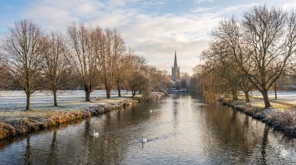 Frosty winter morning on the River Avon with Holy Trinity's spire in the distance