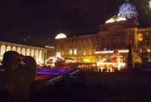 Birmingham's Frankfurt Christmas Market in Victoria Square at night, with the Council House behind