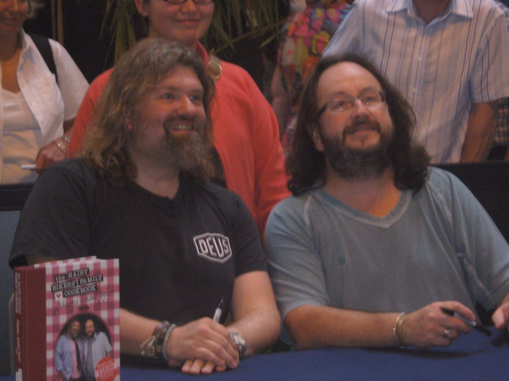 Si King and Dave Myers, the Hairy Bikers, smiling at a book signing